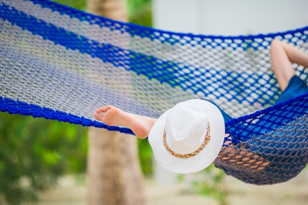 Woman relaxing on hammock on tropical vacationの写真素材