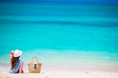 Young beautiful woman relaxing at white sand tropical beachの写真素材