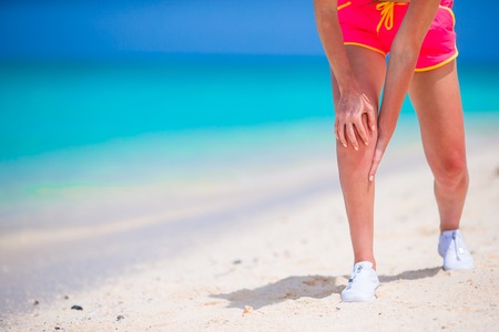 Female Athlete Suffering From Pain In Leg While Exercising