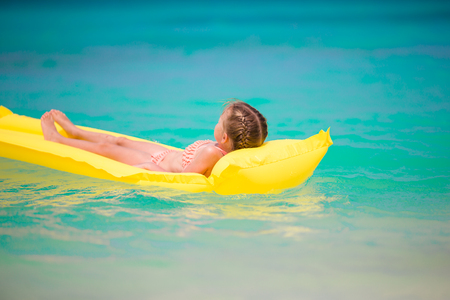 Adorable little girl playing with beach toys during summer vacationの写真素材