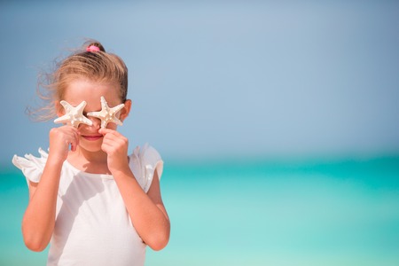 Cute little girl at beach during summer vacationの写真素材