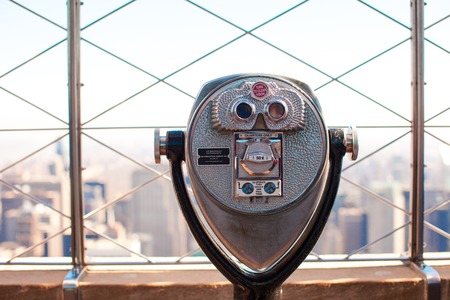 Public telescope pointed on the Manhattan buildingsの写真素材