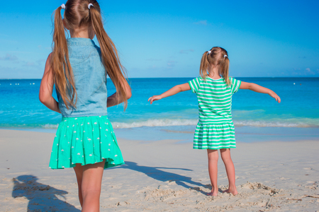 Adorable little sisters at beach during summer vacationの写真素材