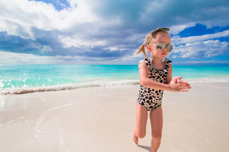 Cute little girl at beach during summer vacationの写真素材