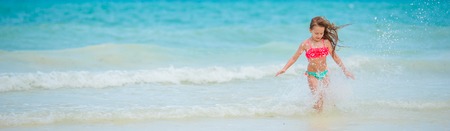 Cute little girl at beach during summer vacationの写真素材
