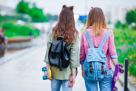 Two hipster cute girls with skate outdoorsの写真素材