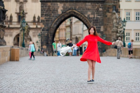 Girl caucasian drinking hot drink coffee walking in street at Europeの写真素材