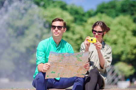 Happy tourist couple, man and woman traveling on holidays in Europe smiling happy. Caucasian couple.