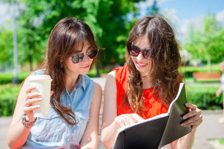Girl caucasian drinking hot drink coffee walking in street at Europeの写真素材