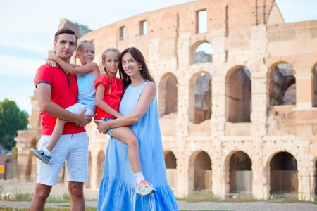 Happy family in Rome over Coliseum backgroundの写真素材
