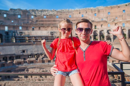 Happy family in Rome over Coliseum backgroundの写真素材
