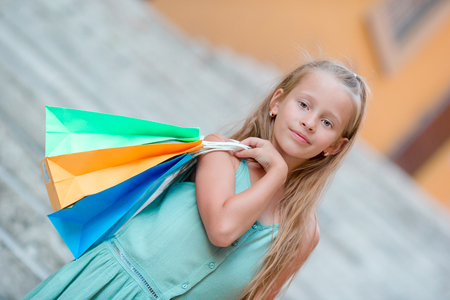 Portrait of adorable little kid with shopping bagsの写真素材