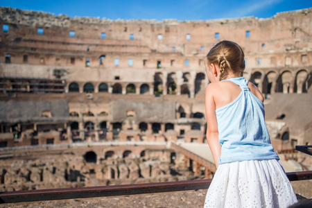 Happy toddler girl in Rome over Coliseum backgroundの写真素材