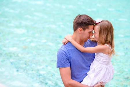 Young man and little girl near Fontana di Trevi with coins in handsの写真素材