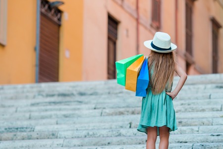 Portrait of adorable little kid with shopping bagsの写真素材