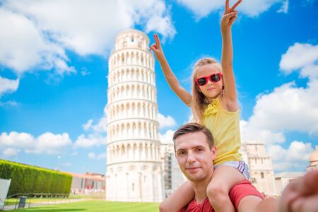 Pisa - travel to famous places in Europe, family portrait in background the Leaning Tower in Pisa, Italyの写真素材