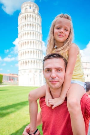 Pisa - travel to famous places in Europe, family portrait in background the Leaning Tower in Pisa, Italyの写真素材