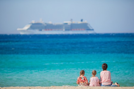 Mother and daughters enjoying time at tropical beachの写真素材