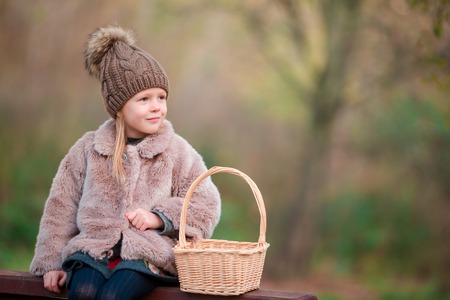 Adorable little girl at beautiful autumn day outdoorsの写真素材