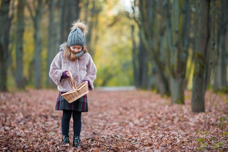 Adorable little girl at beautiful autumn day outdoorsの写真素材