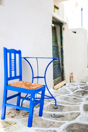 Colorful chairs and table on street of typical greek traditional village with white houses on Mykonos Island, Greece, Europeの写真素材