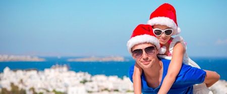 Family in Santa Hats enjoy vacation with beautiful viewの写真素材