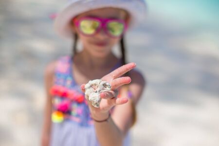 Close up kids hands holding beautiful sea shellsの写真素材