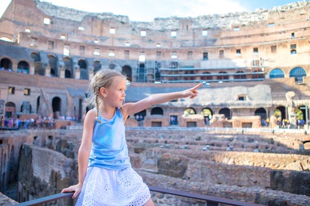 Little girl in Coliseum, Rome, Italy. Cute kid looking at famous places in Europeの写真素材