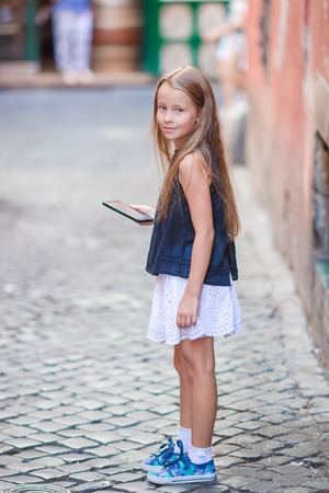 Adorable happy little girl outdoors in european city. Portrait of caucasian kid enjoy summer vacation in Romeの写真素材