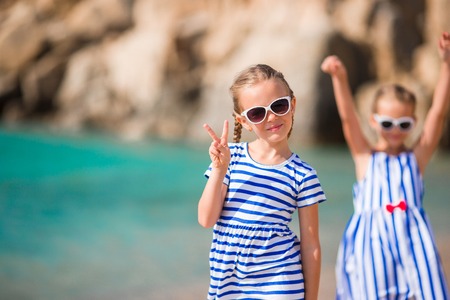 Adorable little girls having fun during beach vacationの写真素材