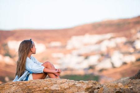 Adorable little girl on beach in the evening with beautiful viewの写真素材