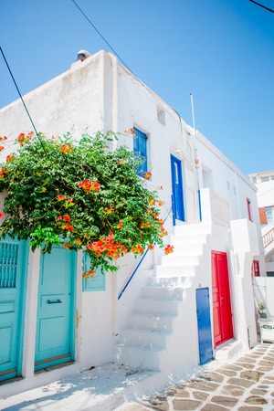 The narrow streets of greek island with trees. Beautiful architecture building exterior with cycladic style.の写真素材