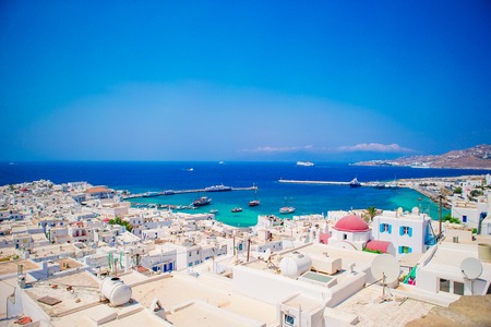 Top view of the old city and the sea on the island of Mykonos, Greece. A lot of white houses against the blue skyの写真素材