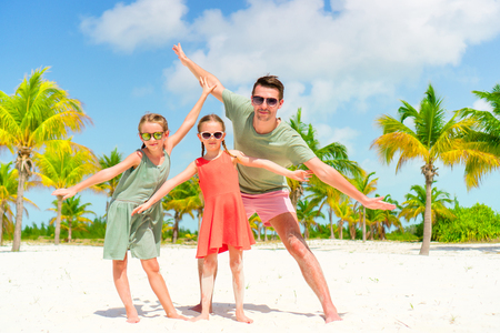 Family walking on white tropical beach on caribbean islandの写真素材