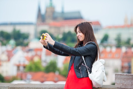 Young caucasian woman taking self portrait in european cityの写真素材