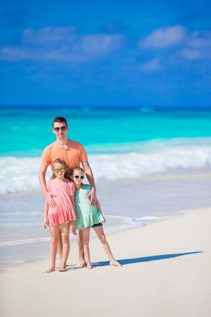 Family of father and kids on white tropical beachの写真素材