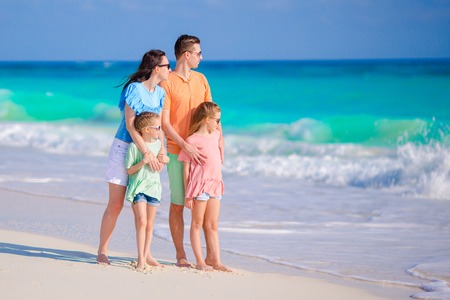 Beautiful family have a lot of fun on the beachの写真素材
