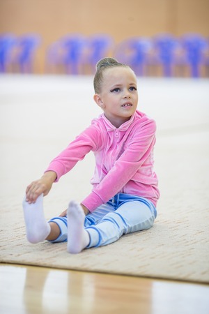 Adorable little girl athletes train in rhythmic gymnastics hallの写真素材