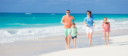 Happy adorable family have a lot of fun on beach vacationの写真素材