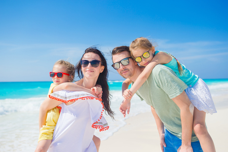 Portrait of happy family on a tropical beachの写真素材