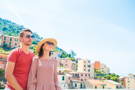 Young family with great view at old village Riomaggiore, Cinque Terre, Liguria, Italy. European italian vacation.の写真素材