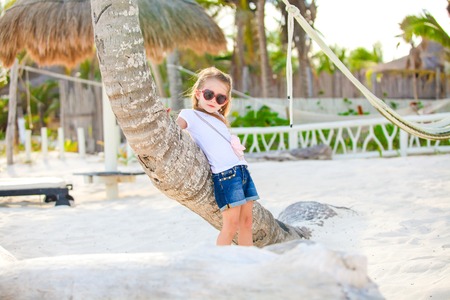 Adorable happy smiling little girl on beach vacationの写真素材