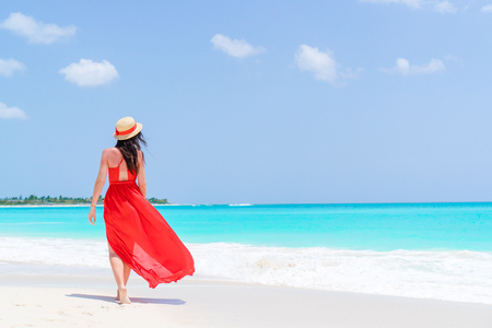 Young woman in hat during tropical beach vacationの写真素材