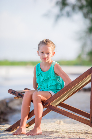 Adorable little girl relaxing in beach chairの写真素材