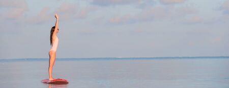 Active young woman on stand up paddle boardの写真素材