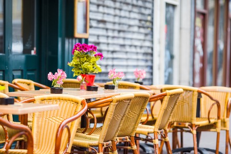 Outdoor cafe on a street of typical greek traditional village in Greece. Coffee on table for breakfastの写真素材