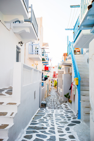 Beautiful streets with blue balconies, stairs and flowers in pots. Beautiful architecture building exterior with cycladic style.の写真素材