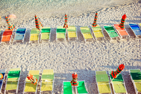 Sunbeds and umbrellas at beautiful european seashore in Monterosso in Italy, Cinque Terre, Liguriaの写真素材