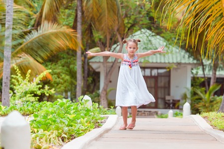 Active little girl at beach having a lot of fun.の写真素材