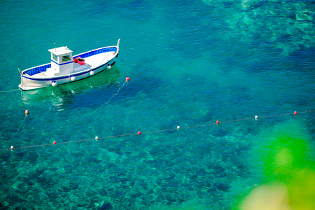 Beautiful cozy bay with boats and clear turquoise water in Italy coast, Manarola, Liguria, Europeの写真素材